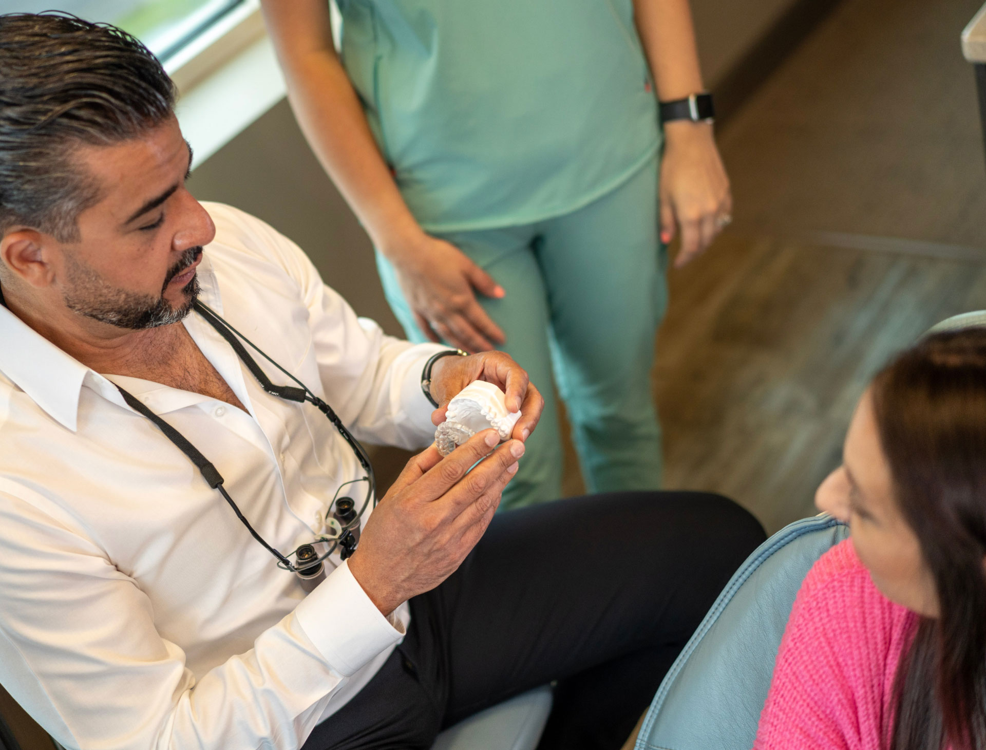 dentist showing patient how to use invisalign
